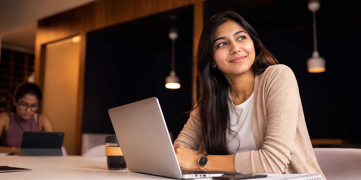 Candidate practising Deloitte interview answers aloud in front of a laptop